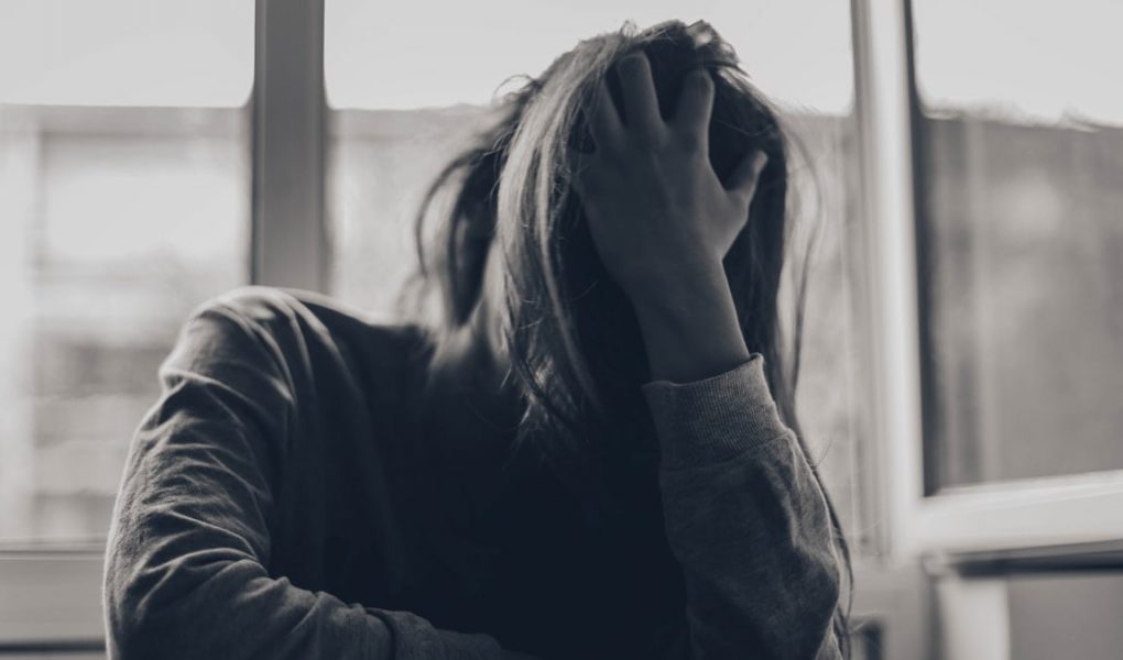 grayscale photography of person covering face