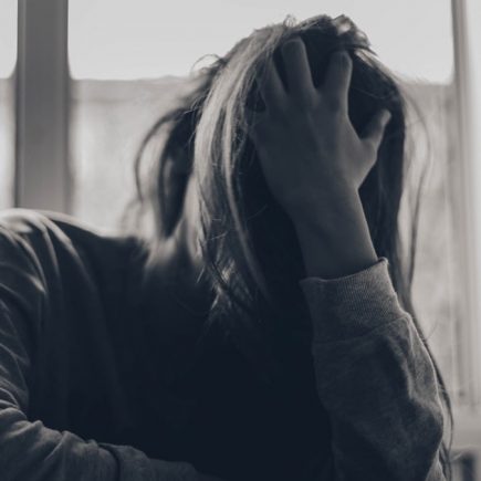 grayscale photography of person covering face